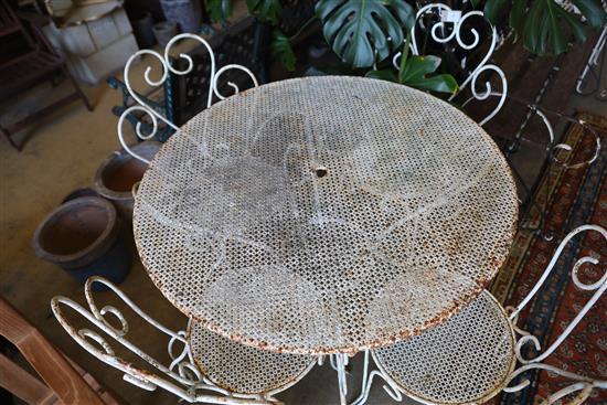 A wrought iron circular garden table and four chairs, table 98cm diameter